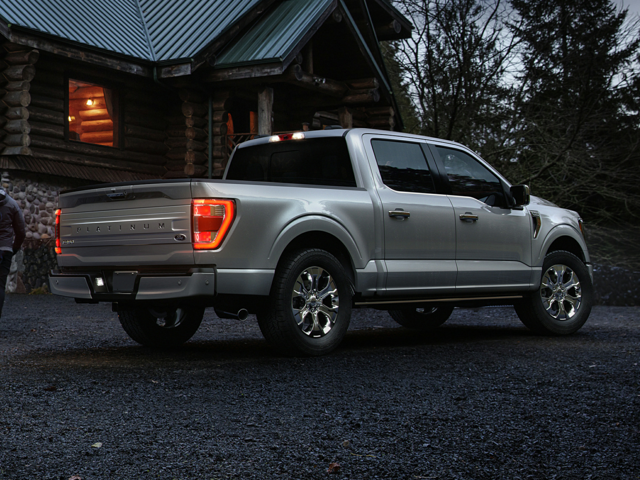 A gray Ford F-150 parked outside of a house