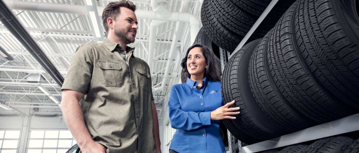 Ford employee showing customer tires